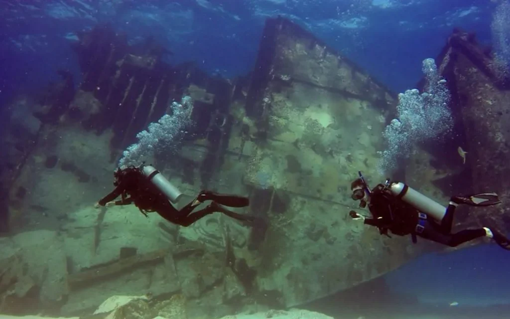 scuba divers investigating a shipwreck in Florida