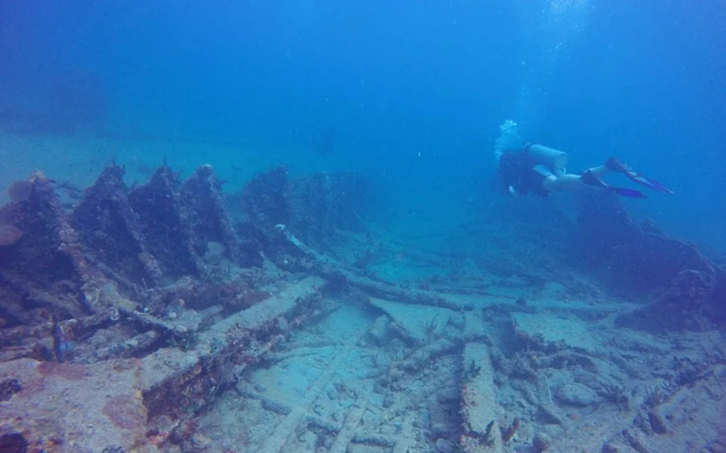 Scuba diver swims over SS Copenhagen shipwreck